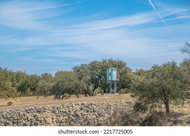 Watch Tower Against Trees And Blue Sky On A Sunny Day In Lake Austin Texas. Outdoor Landscape Near A Lake With A Small Building Construction Designed For Watching The Surrounding Area.