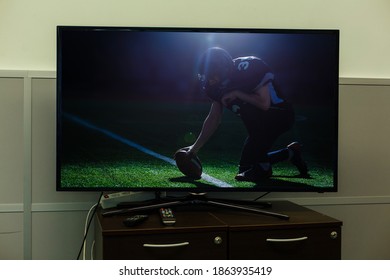 Watching American Football Game On Television At Home. Leisure And Entertainment Concept.