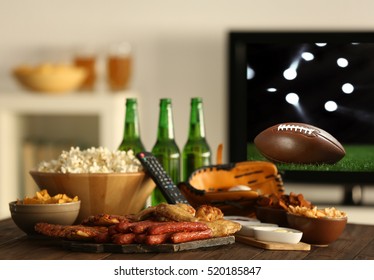 Watching American Football Game On Television At Home. Leisure And Entertainment Concept.