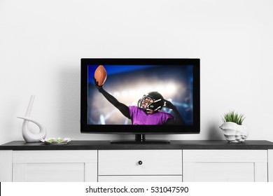 Watching American Football Game On Television At Home. Leisure And Entertainment Concept.