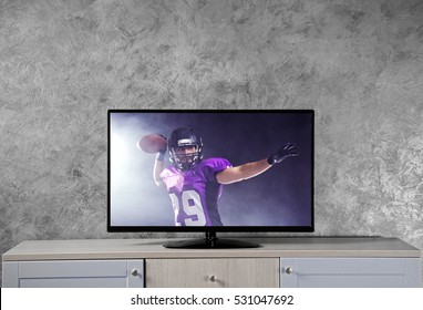 Watching American Football Game On Television At Home. Leisure And Entertainment Concept.