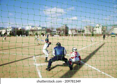 Watching Baseball Game From The Backstop