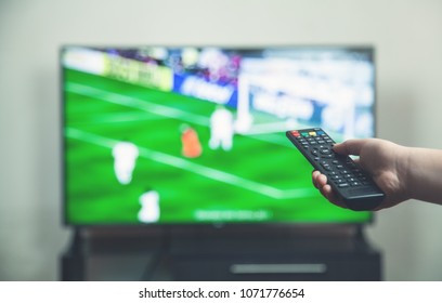  Watching Football Match On Tv With Remote Controller.