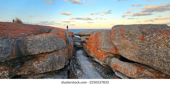 Watching the golden glow of a beautiful rocky coastline sunrise - Powered by Shutterstock