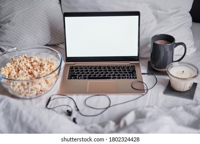 Watching Movie At Home. Popcorn In Bowl And Laptop Computer In Bed. Entertainment Concept.