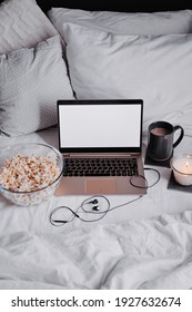 Watching Movie At Home. Popcorn In Bowl And Laptop Computer In Bed. Entertainment Concept.