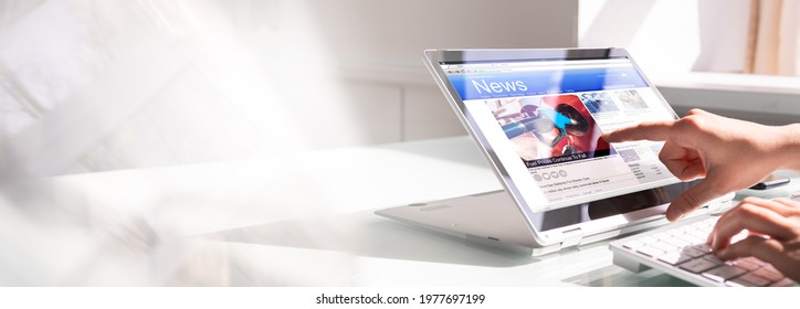 Watching News On Screen. Reading Newspaper Website On Laptop - Shutterstock ID 1977697199