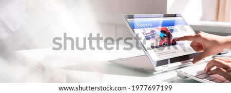 Watching News On Screen. Reading Newspaper Website On Laptop