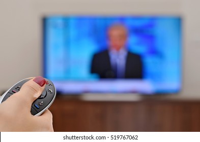 Watching News On TV And Using Remote Controller