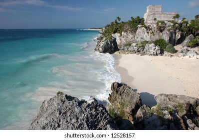 Watching the sandy beach and Tulum ruins from a rock. Tulum. Yucatan. Mexico