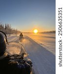 Watching the sunrise whilst on a snowmobile safari in Finnish Lapland.