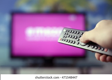 Watching TV And Using Remote Controller
