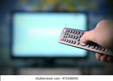 Watching TV And Using Remote Controller
