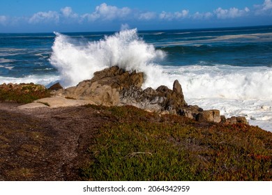 Watching waves crash on a rock by the coast