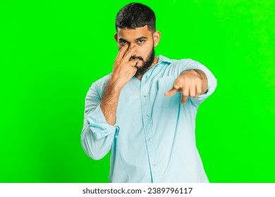 I am watching you. Confident attentive man pointing at her eyes and camera, show I am watching you gesture spying on someone. Handsome disappointed Indian guy isolated on green chroma key background - Powered by Shutterstock