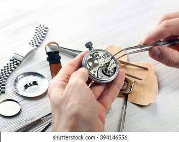 Watchmaker Hands Repairing Mechanism Of Old Watch Closeup