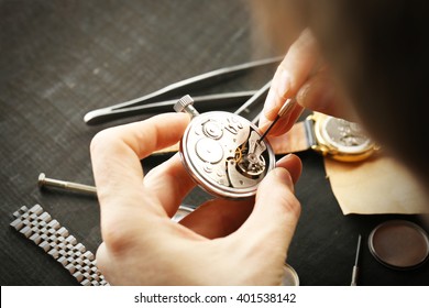 Watchmaker Hands Repairing Mechanism Of Old Watch Closeup