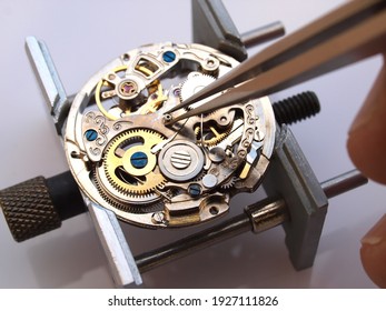 watchmaker repairing classic mechanical watch movement    