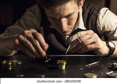 The watchmaker is repairing the mechanical watches in his workshop - Powered by Shutterstock