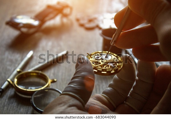The watchmaker is repairing the mechanical\
watches in his workshop