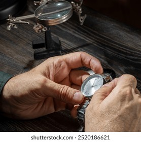 Watchmaker repairing watches looking through magnifying glass monocular. Professional senior watch fixer in repair services workshop - Powered by Shutterstock