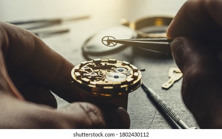 Watchmaker is repearing mechanical wrist watch