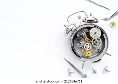 Watchmaker Tools Near Watch Mechanism Of Alarm Clock