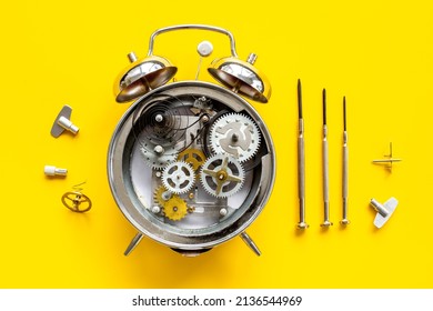 Watchmaker Tools Near Watch Mechanism Of Alarm Clock