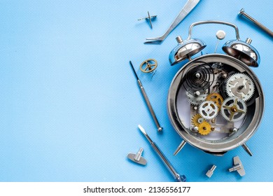 Watchmaker Tools Near Watch Mechanism Of Alarm Clock