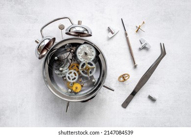 Watchmaker Tools Near Watch Mechanism Of Alarm Clock