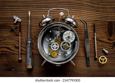 Watchmaker Tools Near Watch Mechanism Of Alarm Clock