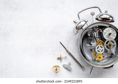 Watchmaker Tools Near Watch Mechanism Of Alarm Clock