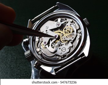 watchmaker working on watch close up detail
