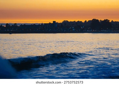 Watcing the waves and setting sun over the Monterey Bay and looking toward West Cliff Drive in Santa Cruz, CA.