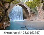 Watefall Portaikos River under arch bridge, Greece