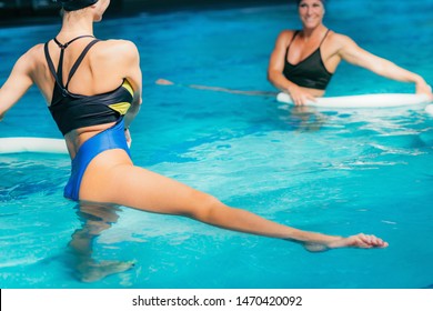 Water Aerobics Class, Group of Women Exercising with Instructor