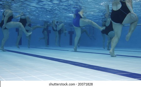 A water aerobics class. Underwater picture.