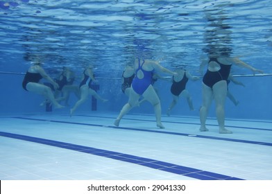 A water aerobics class. Underwater picture.