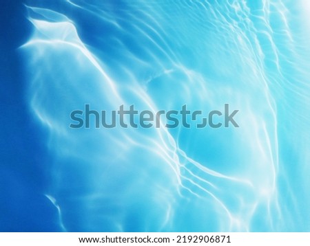 Closeup​ blur​ abstract​ of​ surface​ blue​ water. Abstract​ of​ surface​ blue​ water​ reflected​ with​ sunlight​ for​ background.Top​ view​ of blue​ water.​ Water​ splashed​ use​ for​ graphic​ art.
