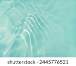 Closeup​ blur​ abstract​ of​ surface​ blue​ water. Abstract​ of​ surface​ blue​ water​ reflected​ with​ sunlight​ for​ background.Top​ view​ of blue​ water.​ Water​ splashed​ abstract​ background.