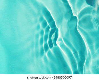 Closeup​ blur​ abstract​ of​ surface​ blue​ water. Abstract​ of​ surface​ blue​ water​ reflected​ with​ sunlight​ for​ background.Top​ view​ of blue​ water.​ Water​ splashed​ abstract​ background.