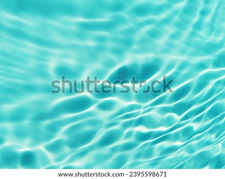 Closeup​ blur​ abstract​ of​ surface​ blue​ water. Abstract​ of​ surface​ blue​ water​ reflected​ with​ sunlight​ for​ background.Top​ view​ of blue​ water.​ Water​ splashed​ abstract​ background.