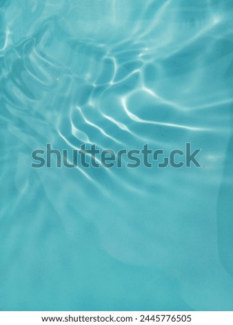 Closeup​ blur​ abstract​ of​ surface​ blue​ water. Abstract​ of​ surface​ blue​ water​ reflected​ with​ sunlight​ for​ background.Top​ view​ of blue​ water.​ Water​ splashed​ abstract​ background.