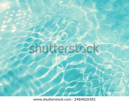Closeup​ blur​ abstract​ of​ surface​ blue​ water. Abstract​ of​ surface​ blue​ water​ reflected​ with​ sunlight​ for​ background.Top​ view​ of blue​ water.​ Water​ splashed​ abstract​ background.