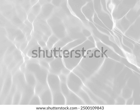 Closeup​ blur​ abstract​ of​ surface​ blue​ water. Abstract​ of​ surface​ blue​ water​ reflected​ with​ sunlight​ for​ background.Top​ view​ of blue​ water.​ Water​ splashed​ abstract​ background.