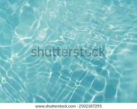 Closeup​ blur​ abstract​ of​ surface​ blue​ water. Abstract​ of​ surface​ blue​ water​ reflected​ with​ sunlight​ for​ background.Top​ view​ of blue​ water.​ Water​ splashed​ abstract​ background.