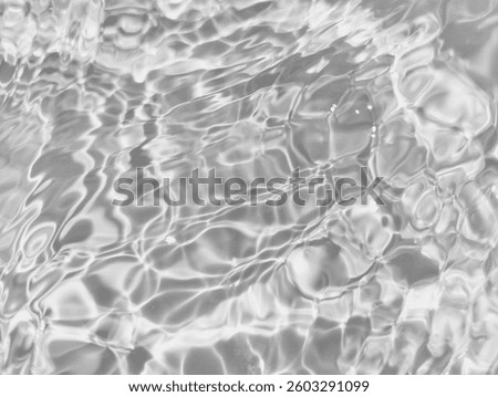 Closeup​ blur​ abstract​ of​ surface​ blue​ water. Abstract​ of​ surface​ blue​ water​ reflected​ with​ sunlight​ for​ background.Top​ view​ of blue​ water.​ Water​ splashed​ abstract​ background.