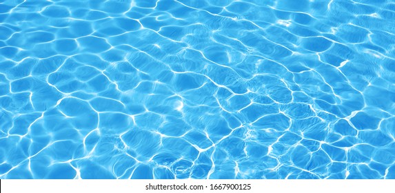 Water background, ripple and flow with waves. Summer blue swiming pool pattern. Sea, ocean surface. Overhead top view with place for text. Panoramic banner. - Powered by Shutterstock