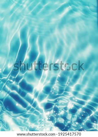 Blur​ abstract​ of​ surface​ blue​ water. Abstract​ of​ surface​ blue​ water​ reflected​ with​ sunlight​ for​ background. Blue​ sea. Blue​ water.​ Water​ splashed​ use​ for​ graphic​ design.