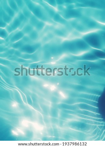 Blur​ abstract​ of​ surface​ blue​ water. Abstract​ of​ surface​ blue​ water​ reflected​ with​ sunlight​ for​ background. Blue​ sea. Blue​ water.​ Water​ splashed​ use​ for​ graphic​ design. Water​